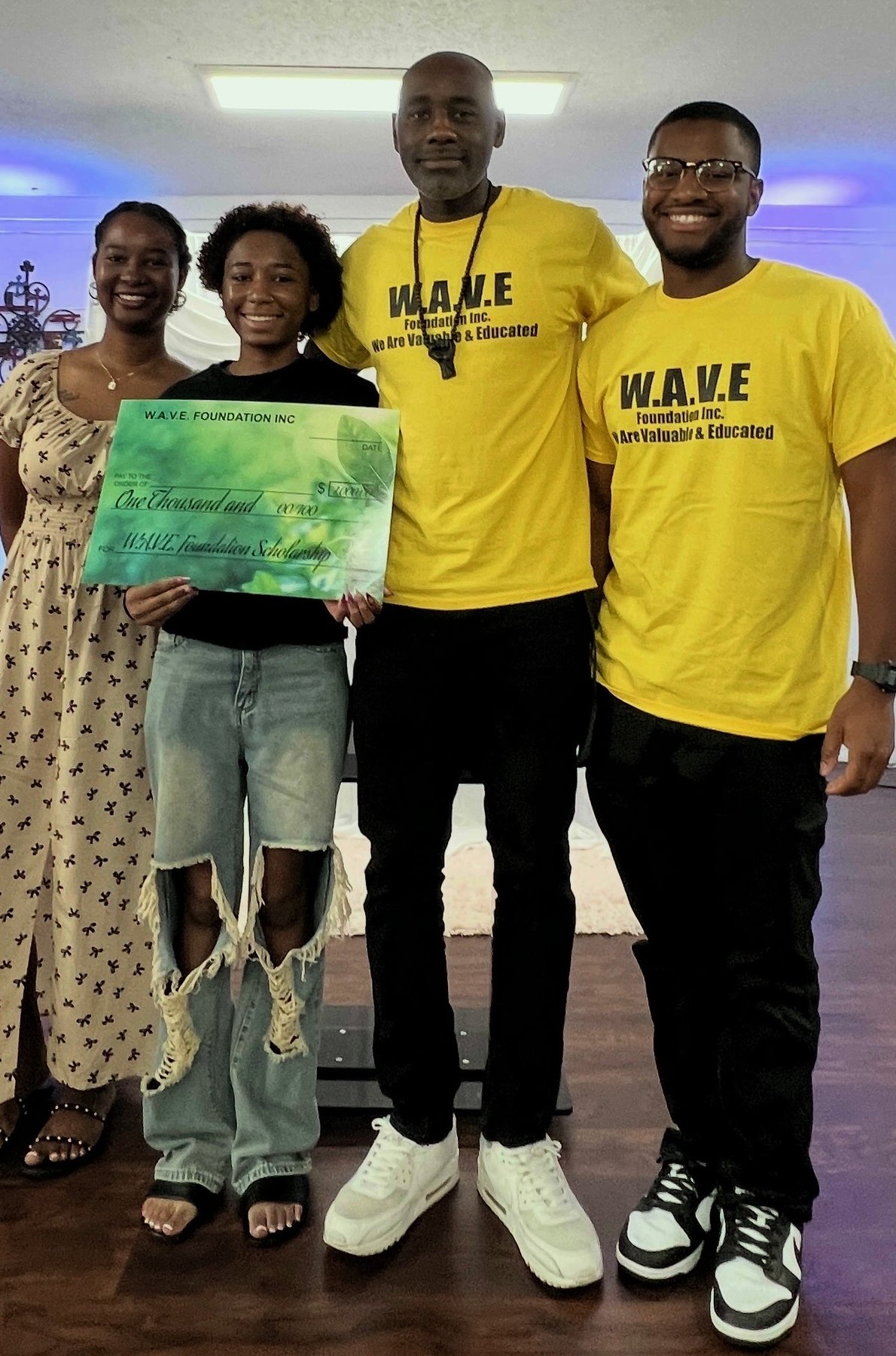 W.A.V.E. Foundation presenting a scholarship award to a student